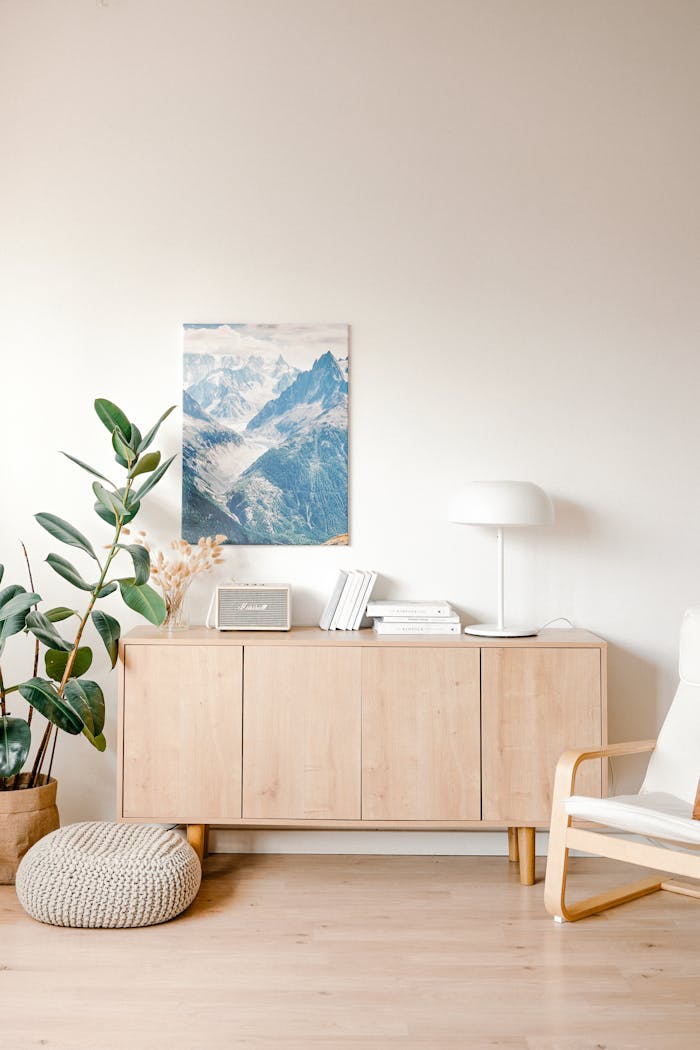 The Art of Drawing Readers In: Your attractive post title goes here A bright, minimalist room with wooden furniture, houseplants, and a mountain print.