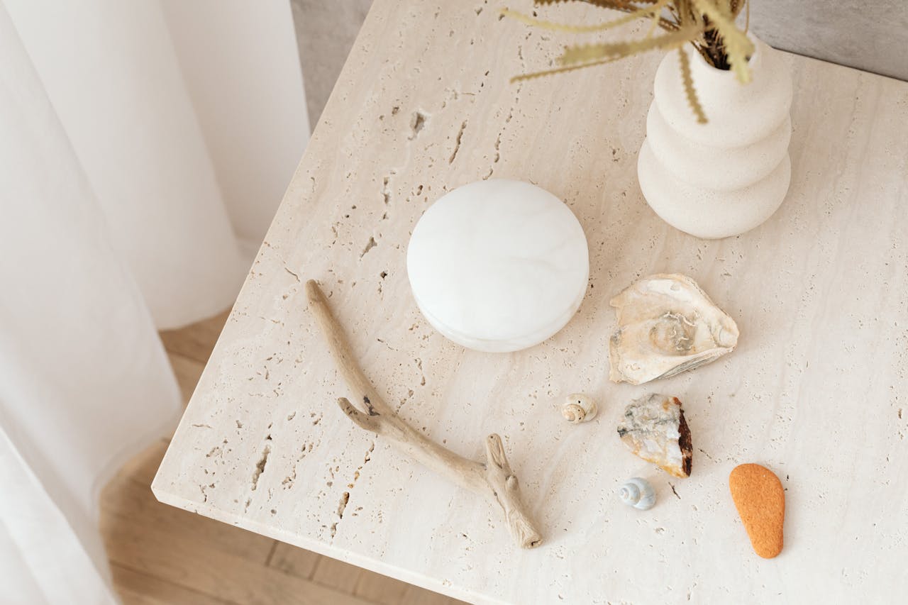 Crafting Captivating Headlines: Your awesome post title goes here Aesthetic still life with seashells, driftwood, and vase on a marble table.