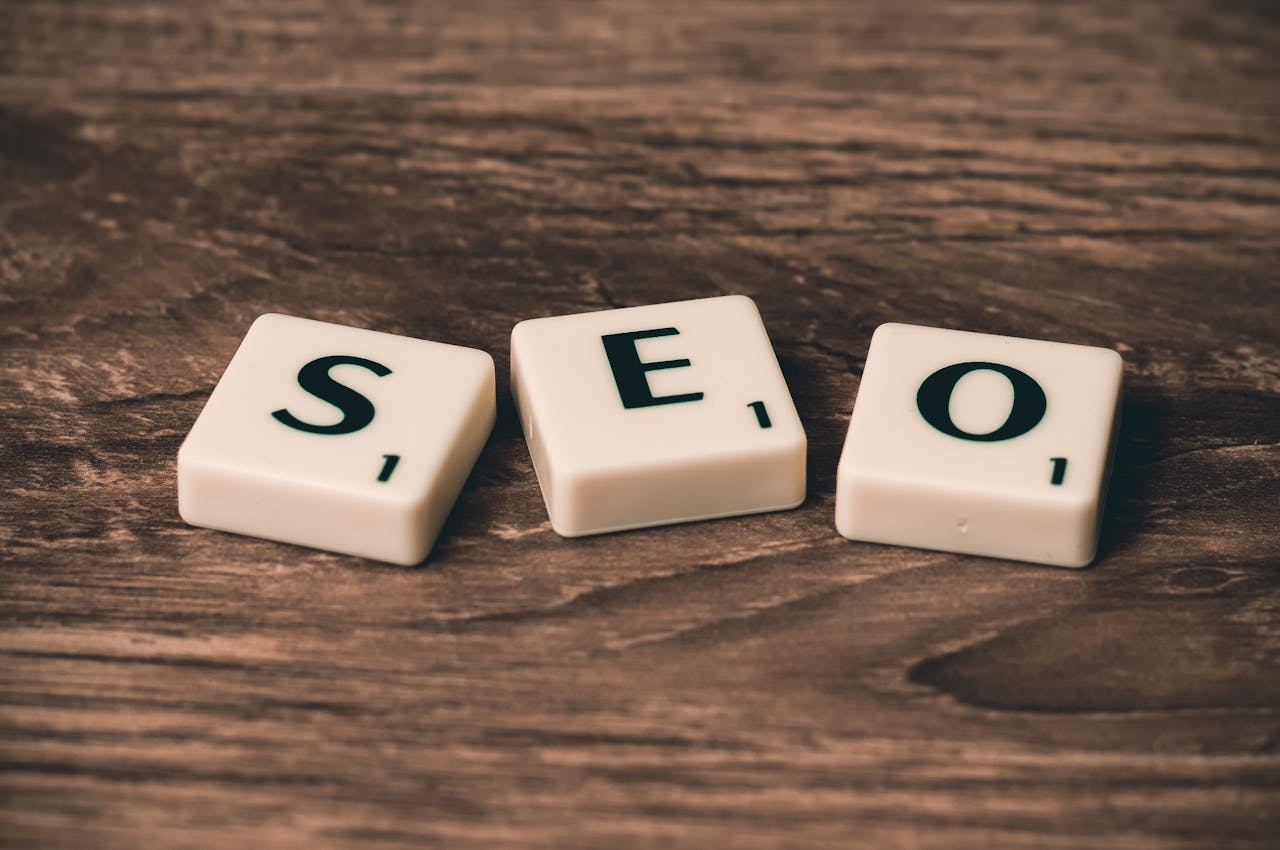 class-02 Scrabble tiles spelling SEO on a wooden surface. Ideal for digital marketing themes.